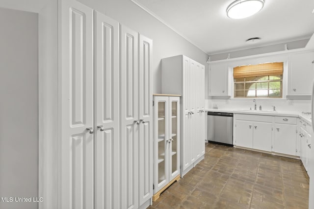 kitchen featuring white cabinets, dishwasher, a sink, and crown molding