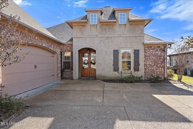 view of front of home with a garage and french doors