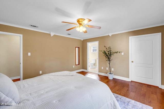 bedroom featuring wood-type flooring, visible vents, ornamental molding, and baseboards