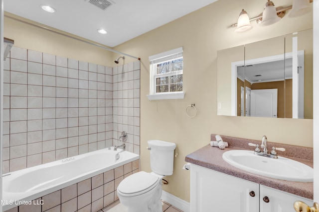 bathroom featuring visible vents, toilet, tiled shower / bath combo, vanity, and recessed lighting