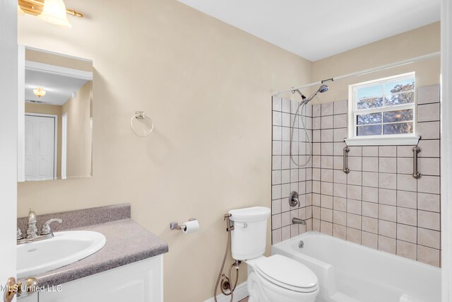 bathroom featuring toilet, bathing tub / shower combination, and vanity