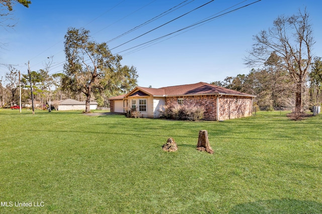 view of front of property with brick siding, an attached garage, and a front yard