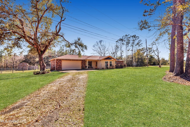 view of front of property with driveway, an attached garage, fence, a front lawn, and brick siding