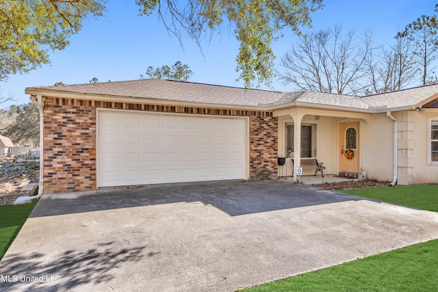 ranch-style home featuring driveway, brick siding, an attached garage, and a shingled roof