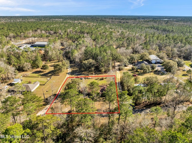 drone / aerial view featuring a forest view