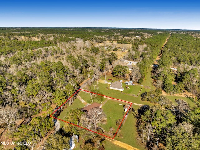 birds eye view of property featuring a view of trees