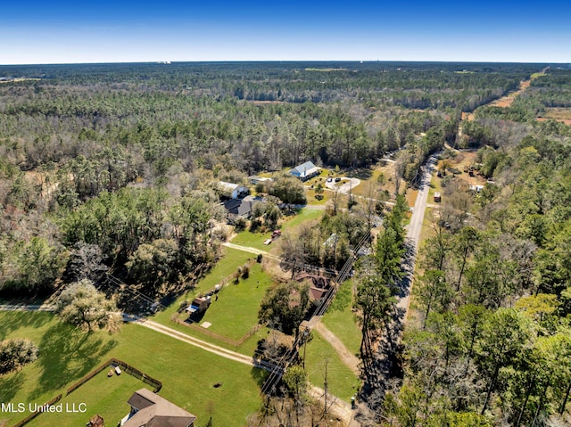 drone / aerial view featuring a rural view and a forest view