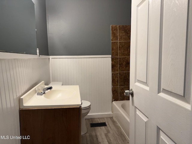 217 S Sunset Ter, Jackson, MS 39212 - bathroom with wood-type flooring, vanity, and toilet