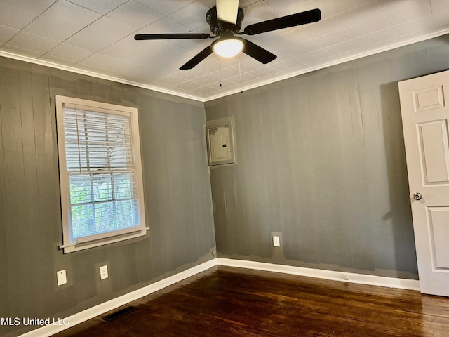 217 S Sunset Ter, Jackson, MS 39212 - spare room with ceiling fan, dark hardwood / wood-style flooring, ornamental molding, and wooden walls