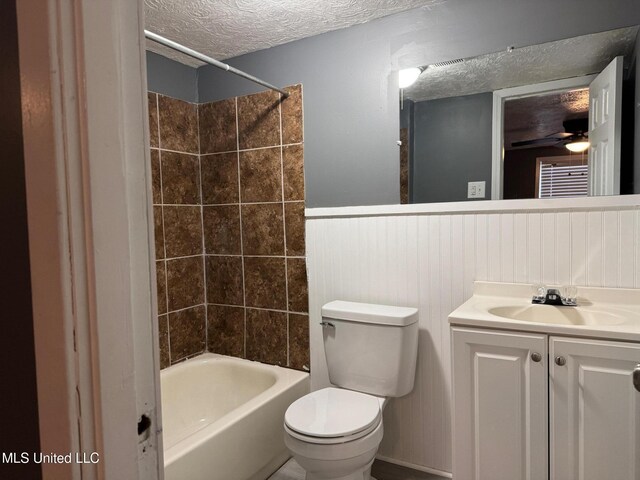 217 S Sunset Ter, Jackson, MS 39212 - full bathroom featuring vanity, a textured ceiling, ceiling fan, toilet, and tiled shower / bath