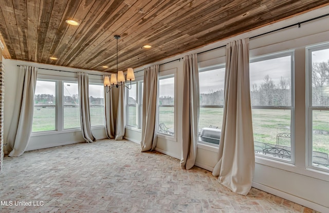 unfurnished sunroom with a water view and wooden ceiling