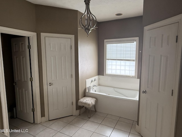 302 Chatfield Cv, Madison, MS 39110 - full bathroom featuring a garden tub, tile patterned floors, and a chandelier