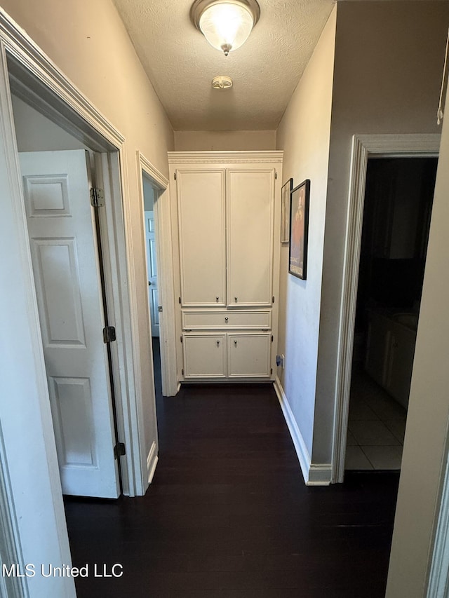 302 Chatfield Cv, Madison, MS 39110 - hallway featuring baseboards, a textured ceiling, and dark wood-style flooring