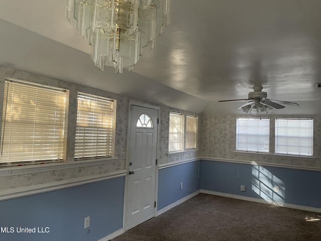 carpeted foyer with lofted ceiling, a wealth of natural light, and ceiling fan