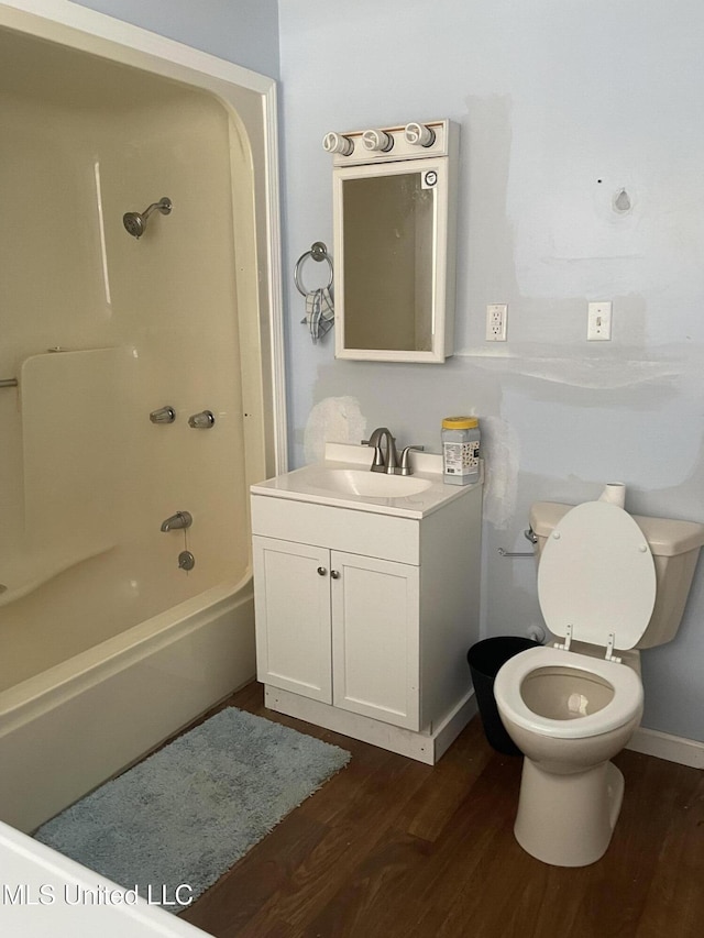 full bathroom with shower / bath combination, vanity, hardwood / wood-style floors, and toilet