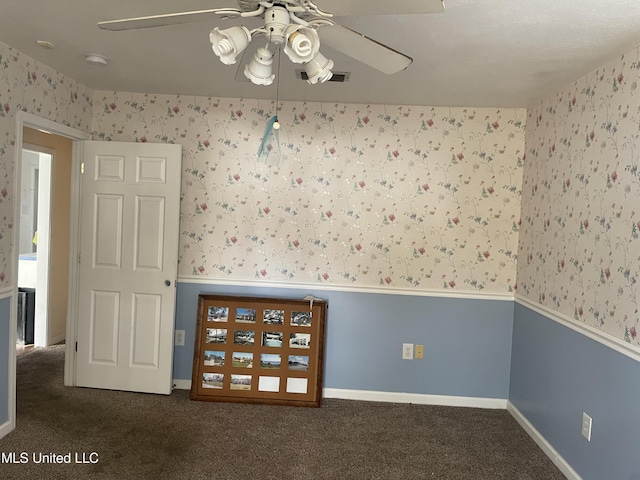 unfurnished room featuring dark carpet and ceiling fan