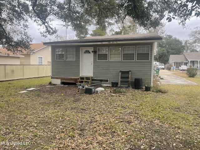 back of house with a yard and central air condition unit