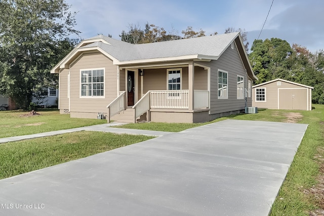 view of front of house featuring a front yard, a porch, a storage unit, and cooling unit