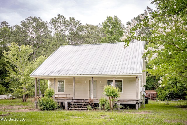 134 Lynne Ln, Lucedale, MS 39452 - view of front of house featuring covered porch, metal roof, and a front yard