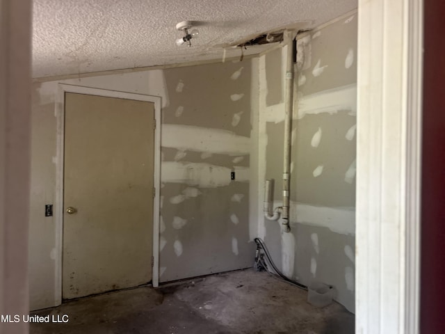 2652 Windward Dr, Gautier, MS 39553 - miscellaneous room with a textured ceiling and unfinished concrete flooring