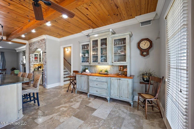 kitchen with butcher block counters, beam ceiling, wooden ceiling, crown molding, and ceiling fan