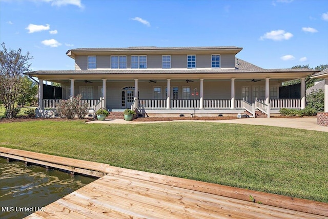 country-style home with a front yard, a porch, and ceiling fan