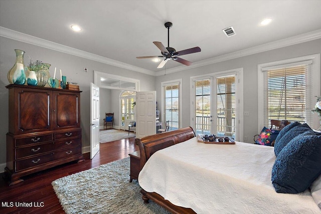 bedroom featuring ornamental molding, dark wood-type flooring, multiple windows, and ceiling fan