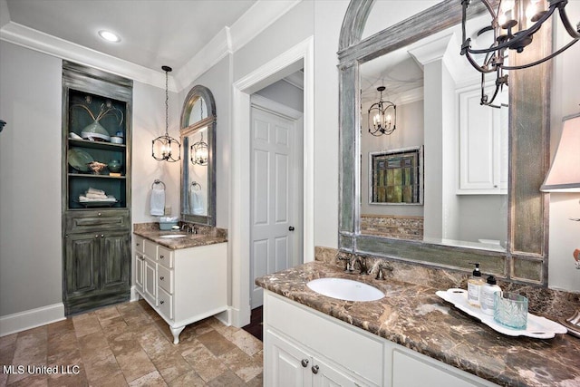 bathroom featuring vanity, crown molding, and a notable chandelier