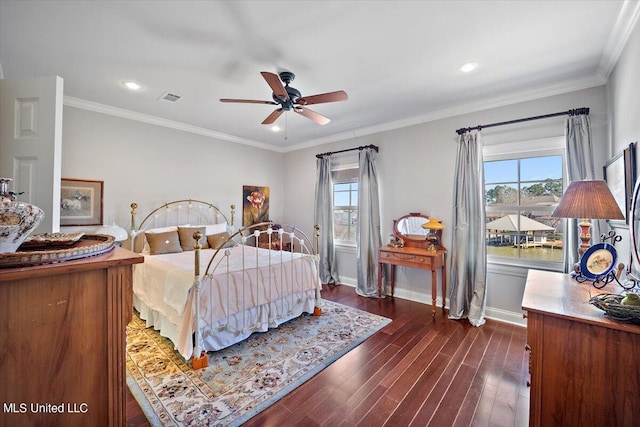 bedroom with ornamental molding, dark wood-type flooring, and ceiling fan