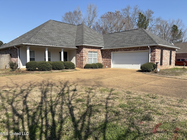 view of front of house featuring a garage, brick siding, a front yard, and a shingled roof