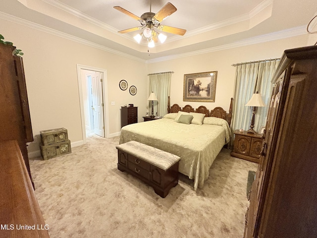 bedroom featuring a raised ceiling, ornamental molding, a ceiling fan, light carpet, and baseboards