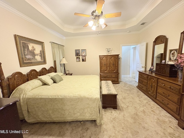 bedroom featuring visible vents, a tray ceiling, ceiling fan, and light colored carpet