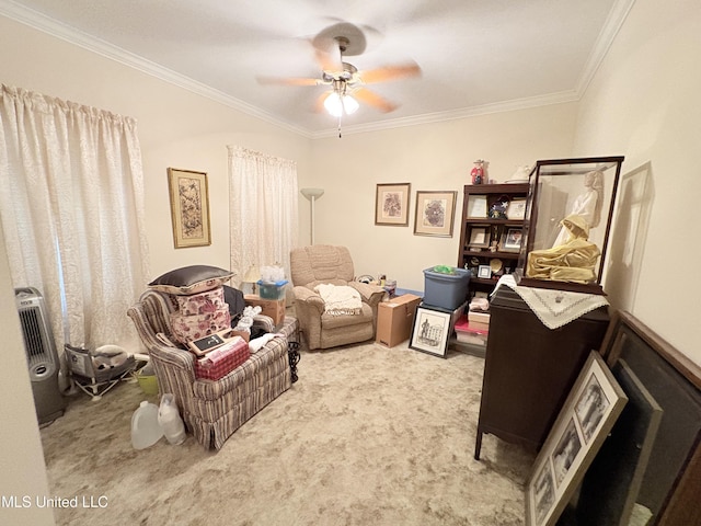 sitting room featuring carpet, ceiling fan, and crown molding