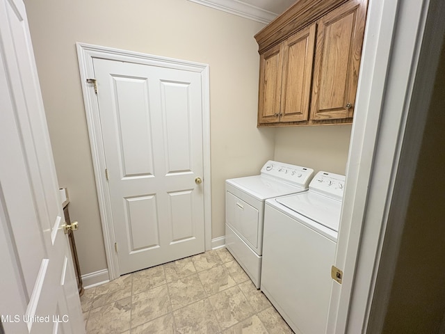 laundry area featuring cabinet space, baseboards, washer and dryer, and ornamental molding