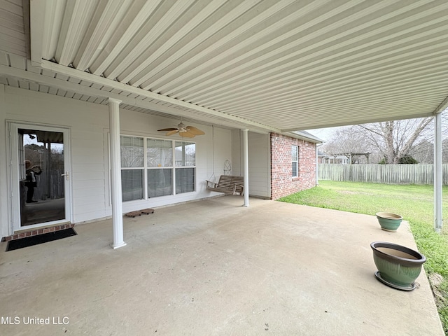 view of patio / terrace featuring fence and a ceiling fan