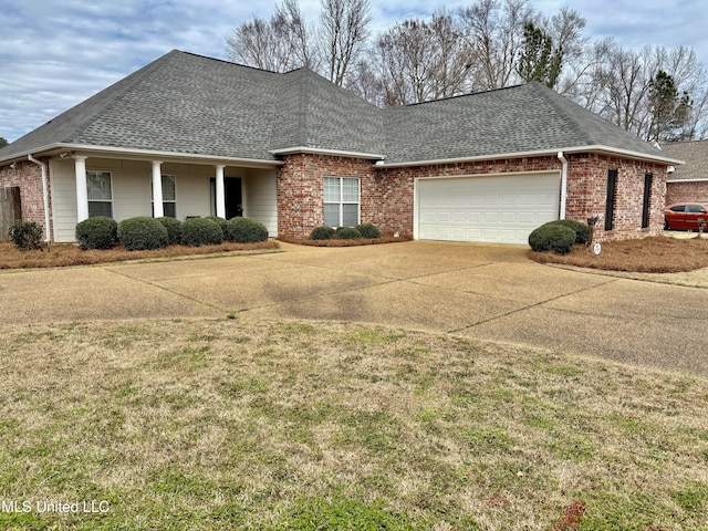 view of front facade with a shingled roof, brick siding, driveway, and an attached garage