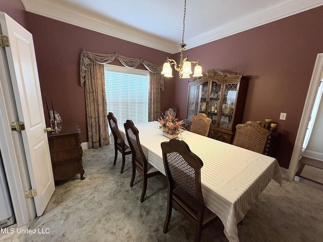 carpeted dining area with ornamental molding, baseboards, and an inviting chandelier