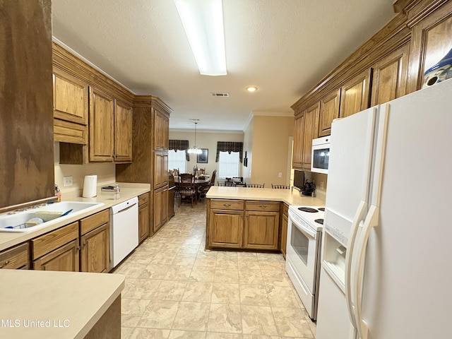 kitchen featuring white appliances, visible vents, brown cabinetry, a peninsula, and light countertops