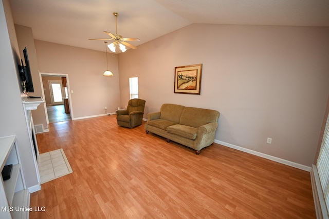 living room with lofted ceiling, visible vents, ceiling fan, light wood-style flooring, and baseboards