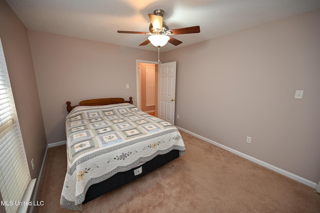 carpeted bedroom featuring baseboards and a ceiling fan