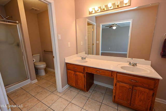full bath with tile patterned floors, a ceiling fan, a stall shower, and a sink