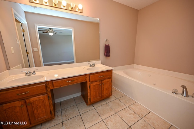 full bathroom featuring tile patterned flooring, a garden tub, double vanity, and a sink
