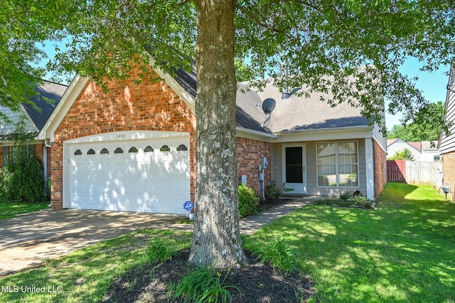view of front facade with a garage, brick siding, fence, and a front yard