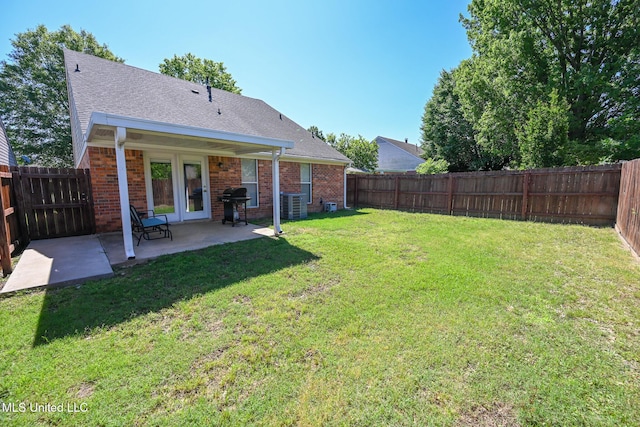 view of yard with central air condition unit, a patio area, and a fenced backyard