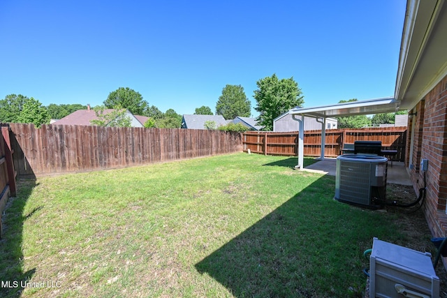 view of yard with central AC unit and a fenced backyard