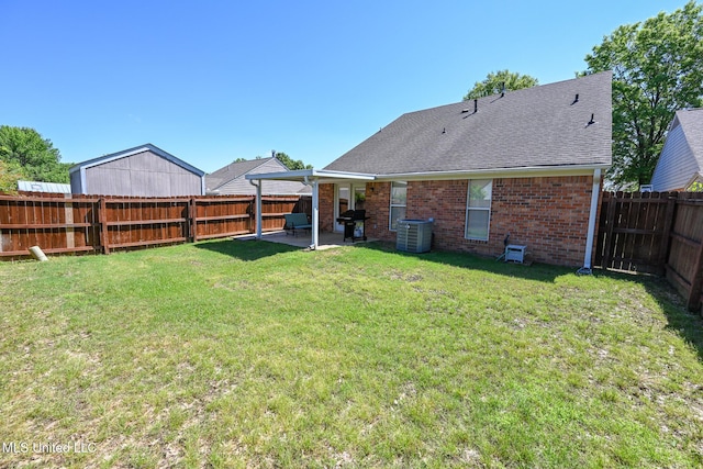 view of yard with central AC unit, a patio area, and a fenced backyard