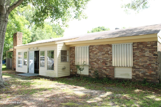 7000 Melrose Dr, Biloxi, MS 39532 - rear view of property with a chimney and brick siding
