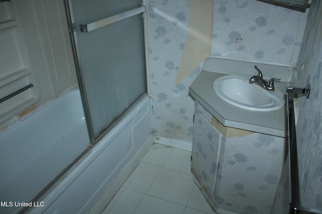 7000 Melrose Dr, Biloxi, MS 39532 - full bath featuring wallpapered walls, tile patterned flooring, vanity, shower / bath combination with glass door, and baseboards