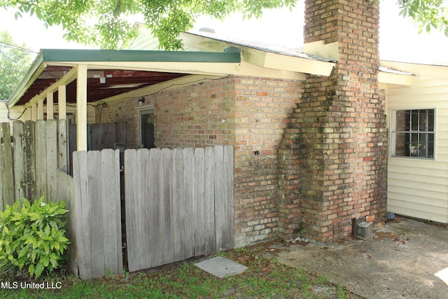 7000 Melrose Dr, Biloxi, MS 39532 - view of property exterior featuring fence, a chimney, and brick siding