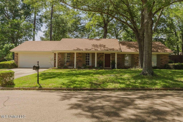 ranch-style house with concrete driveway, an attached garage, and a front lawn
